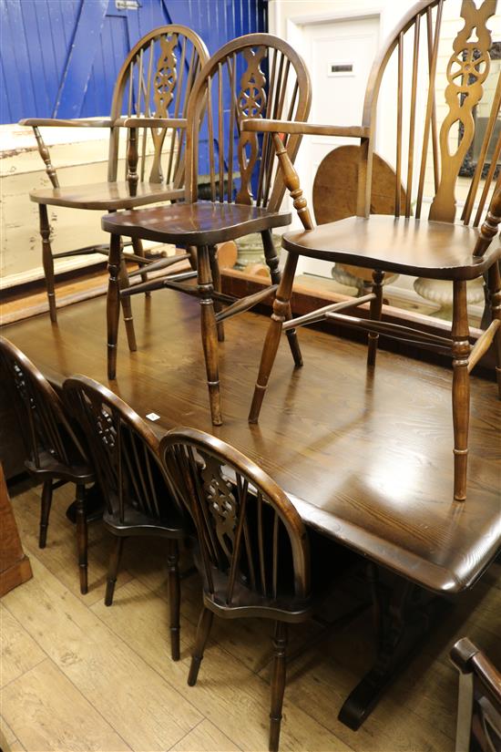 An oak refectory table and a set of six wheelback dining chairs, Table W.184cm